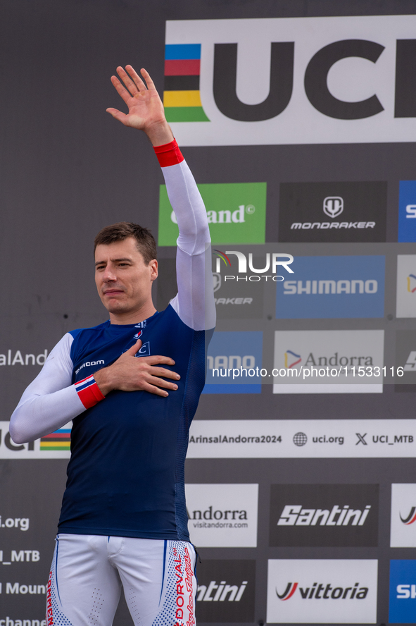 Benoit Coulanges of France stands on the podium at the UCI Mountain Bike World Championships Women Downhill in Pal Arinsal, Andorra, on Augu...