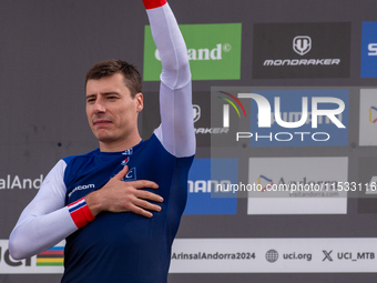 Benoit Coulanges of France stands on the podium at the UCI Mountain Bike World Championships Women Downhill in Pal Arinsal, Andorra, on Augu...