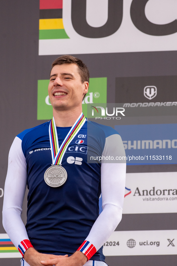 Benoit Coulanges of France stands on the podium at the UCI Mountain Bike World Championships Women Downhill in Pal Arinsal, Andorra, on Augu...