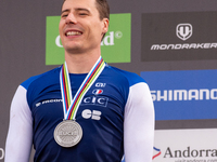 Benoit Coulanges of France stands on the podium at the UCI Mountain Bike World Championships Women Downhill in Pal Arinsal, Andorra, on Augu...