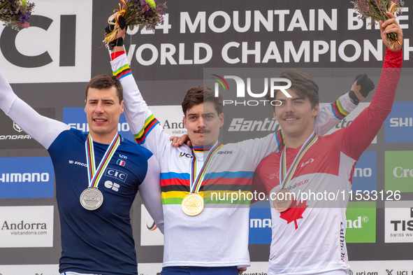 Loris Vergier of France, Finn Iles of Canada, and Benoit Coulanges of France stand on the podium at the UCI Mountain Bike World Championship...