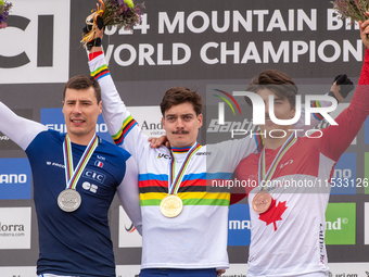 Loris Vergier of France, Finn Iles of Canada, and Benoit Coulanges of France stand on the podium at the UCI Mountain Bike World Championship...