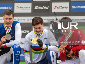 Loris Vergier of France, Finn Iles of Canada, and Benoit Coulanges of France stand on the podium at the UCI Mountain Bike World Championship...