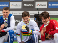 Loris Vergier of France, Finn Iles of Canada, and Benoit Coulanges of France stand on the podium at the UCI Mountain Bike World Championship...