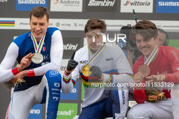 Loris Vergier of France, Finn Iles of Canada, and Benoit Coulanges of France stand on the podium at the UCI Mountain Bike World Championship...