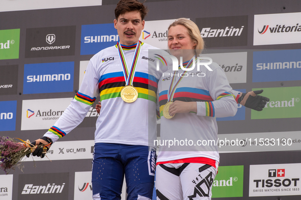 Loris Vergier of France and Valentina Holl of Austria stand on the podium at the UCI Mountain Bike World Championships Men Downhill in Pal A...