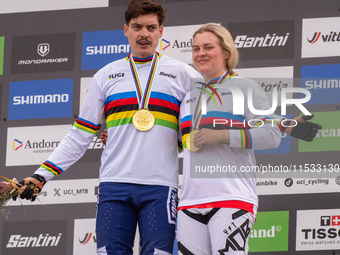 Loris Vergier of France and Valentina Holl of Austria stand on the podium at the UCI Mountain Bike World Championships Men Downhill in Pal A...