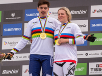 Loris Vergier of France and Valentina Holl of Austria stand on the podium at the UCI Mountain Bike World Championships Men Downhill in Pal A...