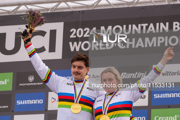 Loris Vergier of France and Valentina Holl of Austria stand on the podium at the UCI Mountain Bike World Championships Men Downhill in Pal A...