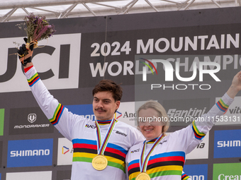 Loris Vergier of France and Valentina Holl of Austria stand on the podium at the UCI Mountain Bike World Championships Men Downhill in Pal A...