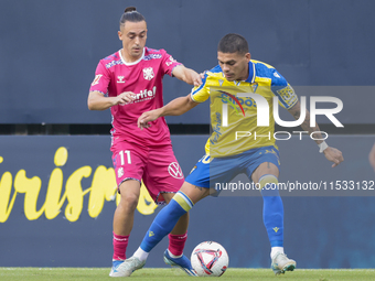 Brian Ocampo of Cadiz CF competes for the ball with Luismi Cruz of CD Tenerife during the Liga Hypermotion match between Cadiz CF and CD Ten...