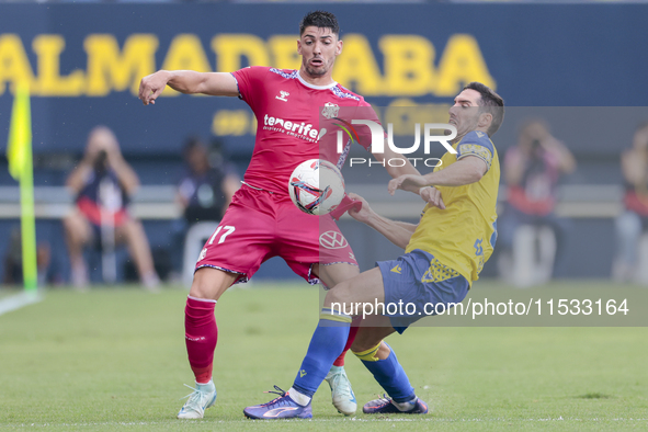 Waldo Rubio of CD Tenerife competes for the ball with Joseba Zaldua of Cadiz CF during the Liga Hypermotion match between Cadiz CF and CD Te...