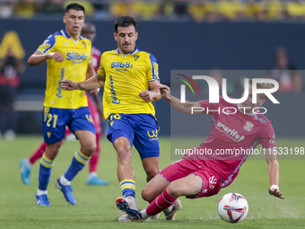 Jose Matos of Cadiz CF competes for the ball with Alejandro Cantero of CD Tenerife during the Liga Hypermotion match between Cadiz CF and CD...