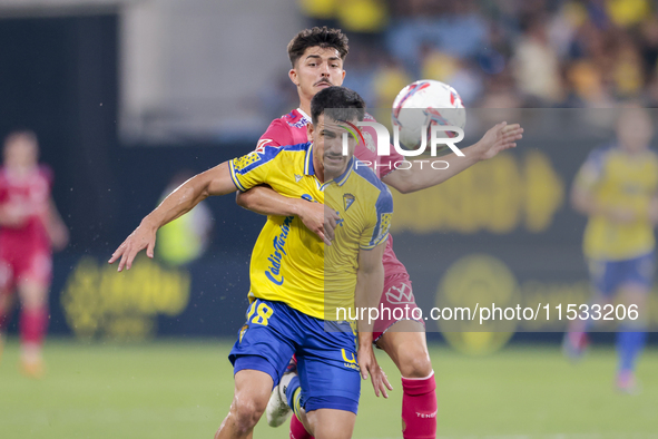 Jose Matos of Cadiz CF competes for the ball with Alassan of CD Tenerife during the Liga Hypermotion match between Cadiz CF and CD Tenerife...