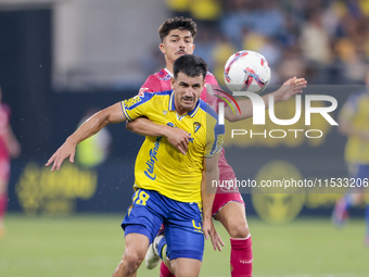 Jose Matos of Cadiz CF competes for the ball with Alassan of CD Tenerife during the Liga Hypermotion match between Cadiz CF and CD Tenerife...