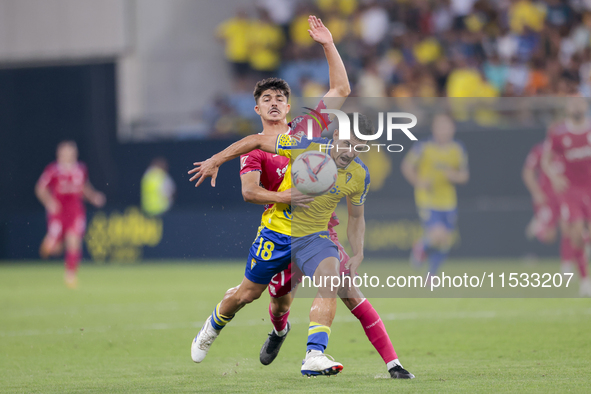 Jose Matos of Cadiz CF competes for the ball with Alassan of CD Tenerife during the Liga Hypermotion match between Cadiz CF and CD Tenerife...