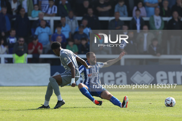 Braintree Town's Kyrell Lisbie is in action with Hartlepool United's Kieron Freeman during the Vanarama National League match between Hartle...