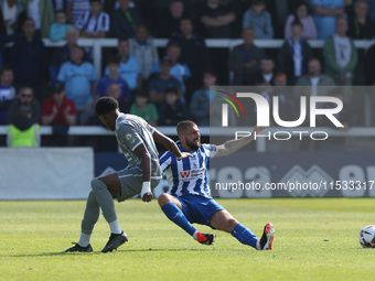 Braintree Town's Kyrell Lisbie is in action with Hartlepool United's Kieron Freeman during the Vanarama National League match between Hartle...