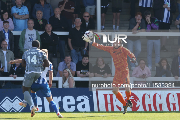 Hartlepool United's Joel Dixon saves from Braintree Town's John Akinde during the Vanarama National League match between Hartlepool United a...