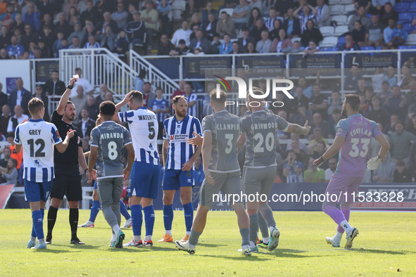 Match referee Matthew McQuillan shows Hartlepool United's Luke Waterfall a red card during the Vanarama National League match between Hartle...