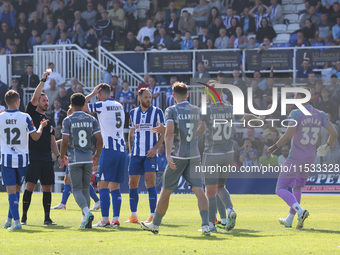 Match referee Matthew McQuillan shows Hartlepool United's Luke Waterfall a red card during the Vanarama National League match between Hartle...