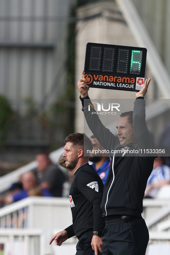 Michael Burrows, the fourth official, indicates the added time with the ''Vanarama National League'' board during the Vanarama National Leag...