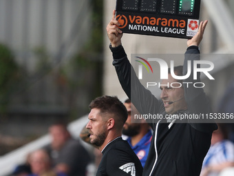 Michael Burrows, the fourth official, indicates the added time with the ''Vanarama National League'' board during the Vanarama National Leag...