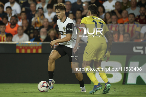 Sergi Canos of Valencia CF (L) and Villarreal's Kiko Femenia during the La Liga match between Valencia CF and Villarreal CF at Mestalla Stad...