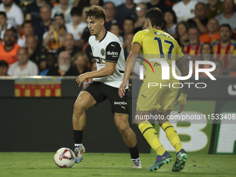 Sergi Canos of Valencia CF (L) and Villarreal's Kiko Femenia during the La Liga match between Valencia CF and Villarreal CF at Mestalla Stad...