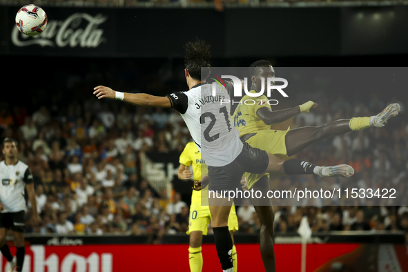 Jesus Vazquez of Valencia CF (left) and Villarreal's Thierno Mamadou Barry during the La Liga match between Valencia CF and Villarreal CF at...