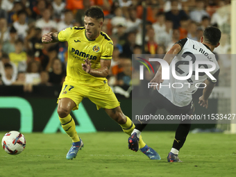 Villarreal's Kiko Femenia (L) and Luis Rioja of Valencia CF during the La Liga match between Valencia CF and Villarreal CF at Mestalla Stadi...