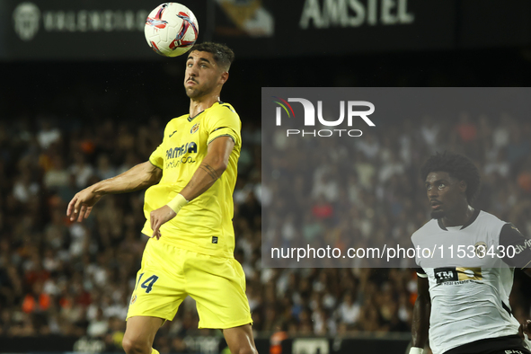 Villarreal's Santi Comesana (left) and Thierry Correia of Valencia CF during the La Liga match between Valencia CF and Villarreal CF at Mest...