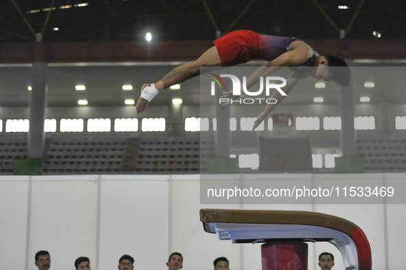 An Artistic Gymnastics athlete of Central Java, Duetto Putraega E, competes in the Group Men's Artistic Vault Final of Indonesia's National...