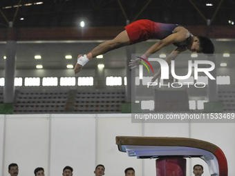 An Artistic Gymnastics athlete of Central Java, Duetto Putraega E, competes in the Group Men's Artistic Vault Final of Indonesia's National...