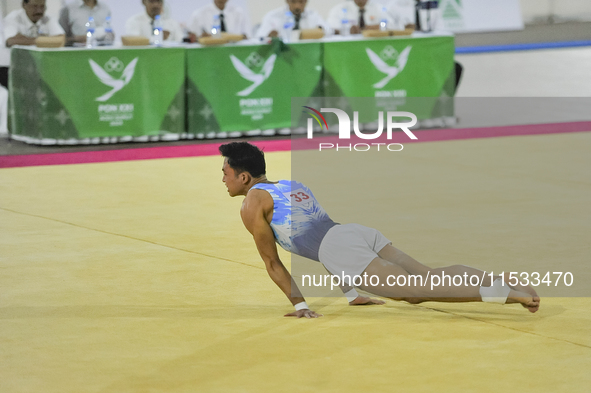 Artistic Gymnastics athlete from DKI Jakarta, Joseph Judah Hatoguan (21), competes in the first round of the men's group match at the Dispor...