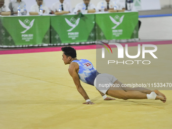 Artistic Gymnastics athlete from DKI Jakarta, Joseph Judah Hatoguan (21), competes in the first round of the men's group match at the Dispor...