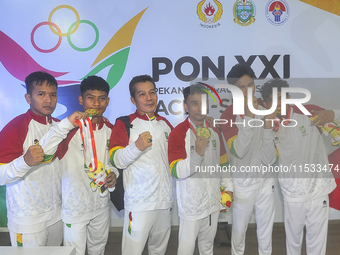 The Riau Contingent Men's Gymnastics athlete team poses together while receiving the gold award on the first day of the Artistic Gymnastics...