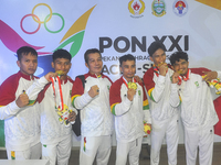 The Riau Contingent Men's Gymnastics athlete team poses together while receiving the gold award on the first day of the Artistic Gymnastics...