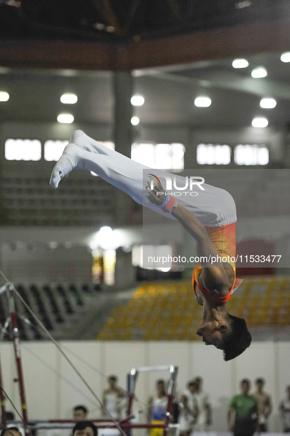 Artistic gymnast from Riau, Rihansyah Agusti, competes in the men's group multilevel crossbar competition in the final round of PON-XXI at t...