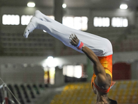 Artistic gymnast from Riau, Rihansyah Agusti, competes in the men's group multilevel crossbar competition in the final round of PON-XXI at t...