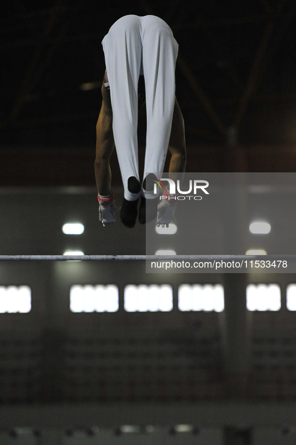 Men's floor artistic gymnast, Farhan Nasani from West Sumatra, competes in front of the jury in the final round at PON XXI at the Sport Cent...