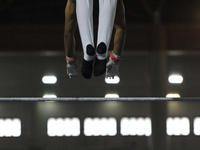 Men's floor artistic gymnast, Farhan Nasani from West Sumatra, competes in front of the jury in the final round at PON XXI at the Sport Cent...