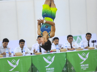 A gymnast from South Sulawesi, Rezha Saputra, spins in the air during the first round match of the men's group per floor apparatus of the XX...