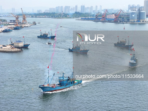 Fishing boats go out to sea from the central fishing port of Yangma Island in Yantai, China, on September 1, 2024. 