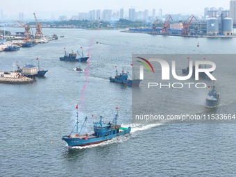 Fishing boats go out to sea from the central fishing port of Yangma Island in Yantai, China, on September 1, 2024. (