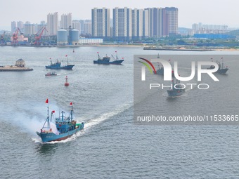 Fishing boats go out to sea from the central fishing port of Yangma Island in Yantai, China, on September 1, 2024. (