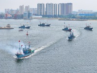 Fishing boats go out to sea from the central fishing port of Yangma Island in Yantai, China, on September 1, 2024. (