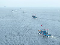 Fishing boats go out to sea from the central fishing port of Yangma Island in Yantai, China, on September 1, 2024. (