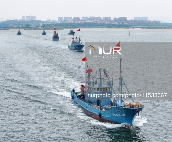 Fishing boats go out to sea from the central fishing port of Yangma Island in Yantai, China, on September 1, 2024. 