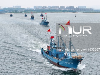 Fishing boats go out to sea from the central fishing port of Yangma Island in Yantai, China, on September 1, 2024. (